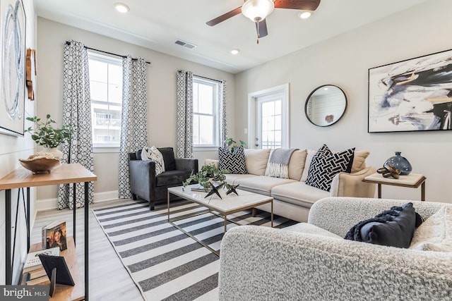 living room with ceiling fan and light wood-type flooring