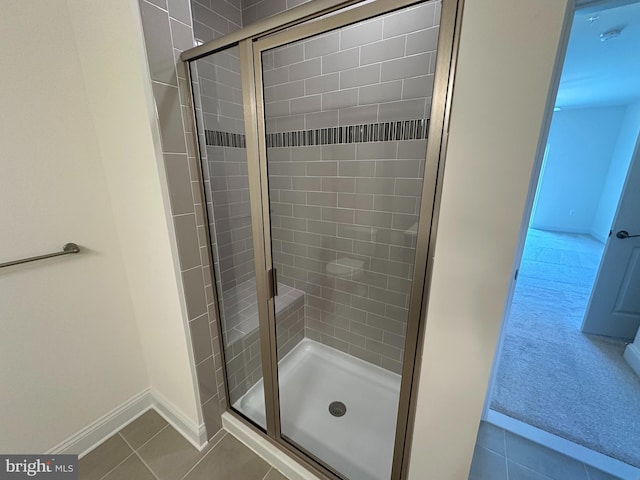 bathroom featuring tile patterned flooring and an enclosed shower