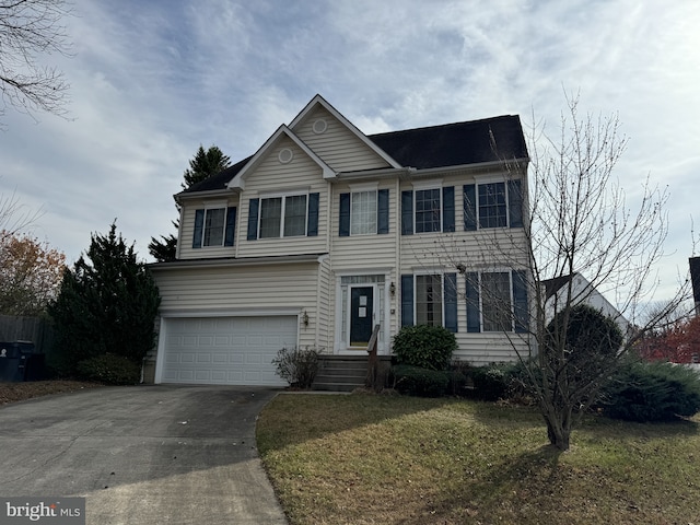 view of front of property with a garage and a front yard