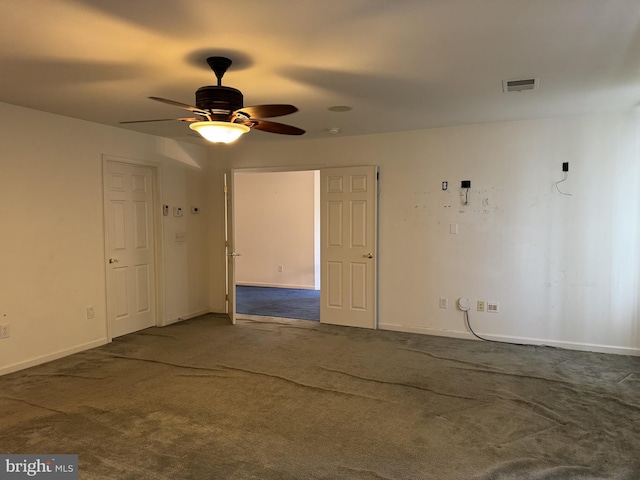 spare room featuring carpet and ceiling fan