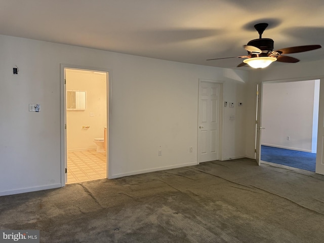 carpeted empty room featuring ceiling fan