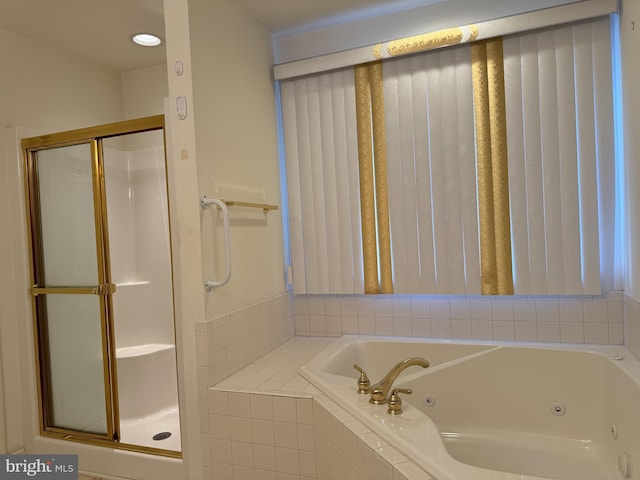 bathroom featuring separate shower and tub