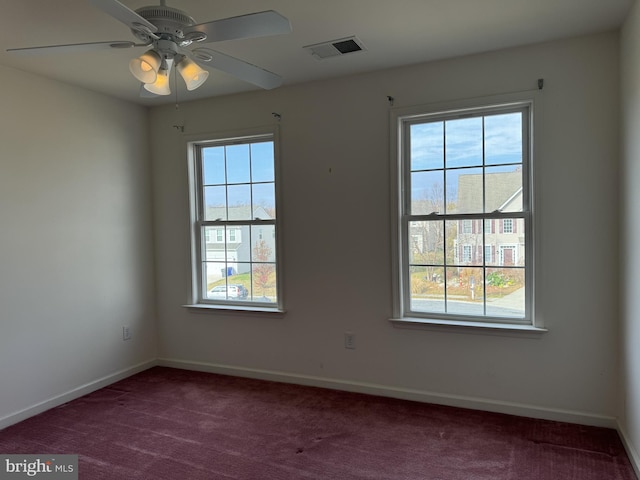 spare room with ceiling fan, a healthy amount of sunlight, and carpet floors