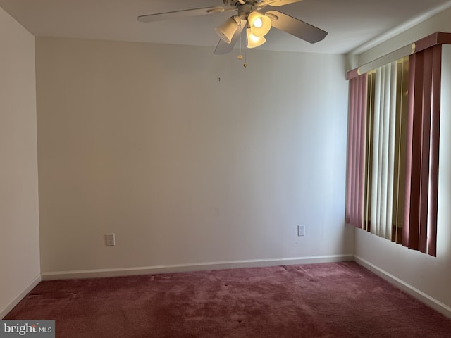 carpeted spare room featuring plenty of natural light and ceiling fan