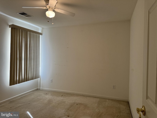 carpeted spare room with ceiling fan