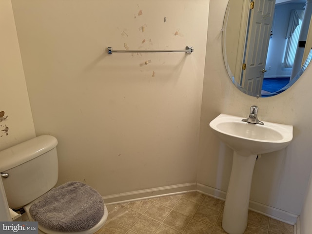 bathroom with tile patterned flooring and toilet