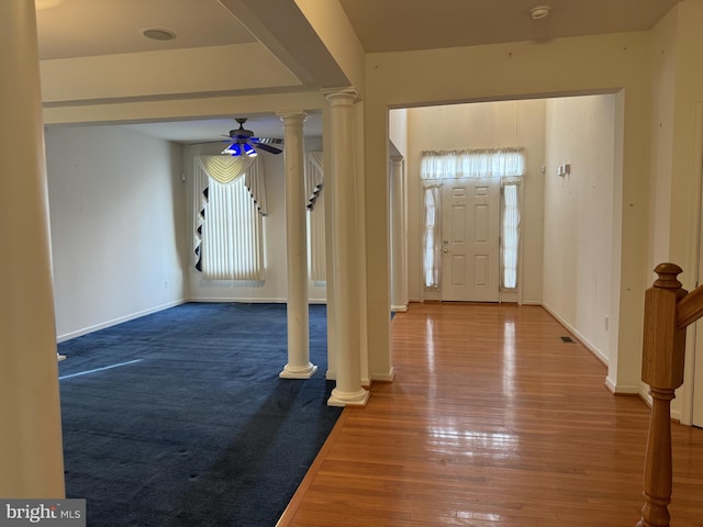 foyer entrance with ceiling fan and wood-type flooring