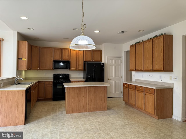 kitchen with black appliances, a center island, sink, and pendant lighting