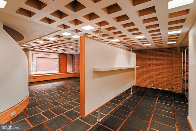 interior space featuring beam ceiling, brick wall, and coffered ceiling