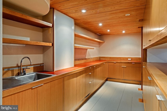 kitchen featuring wooden ceiling and sink