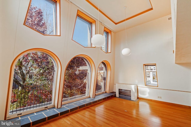 interior space featuring a tile fireplace and hardwood / wood-style flooring