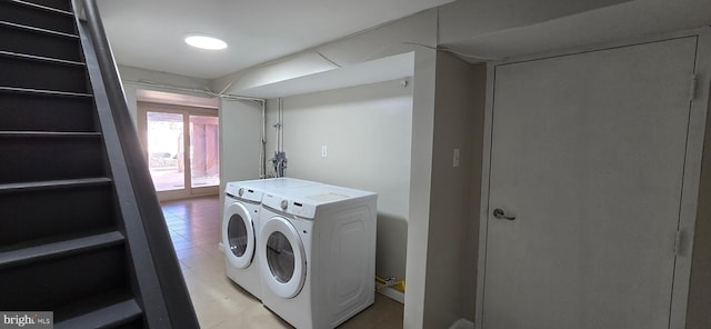 clothes washing area with washing machine and dryer