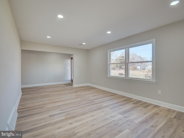 spare room with light hardwood / wood-style flooring