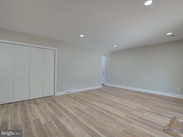 unfurnished bedroom featuring a closet and light hardwood / wood-style flooring