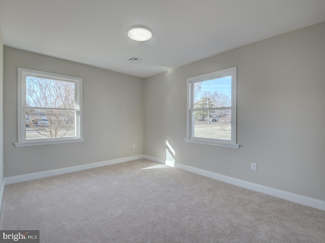 carpeted empty room with a healthy amount of sunlight