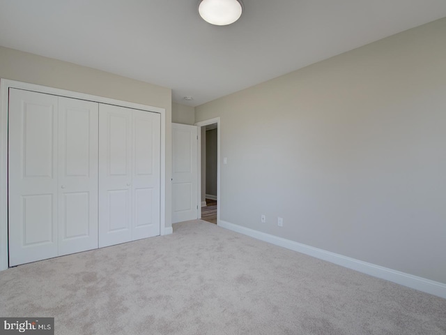 unfurnished bedroom featuring carpet and a closet