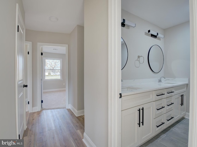 bathroom with hardwood / wood-style floors and vanity