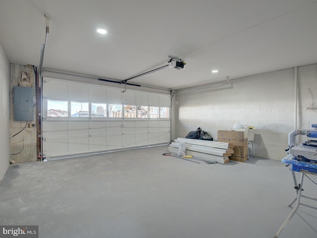 garage featuring electric panel and a garage door opener