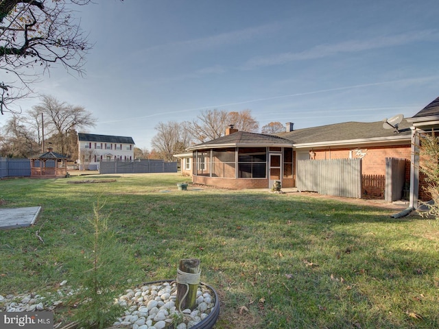 view of yard featuring a sunroom