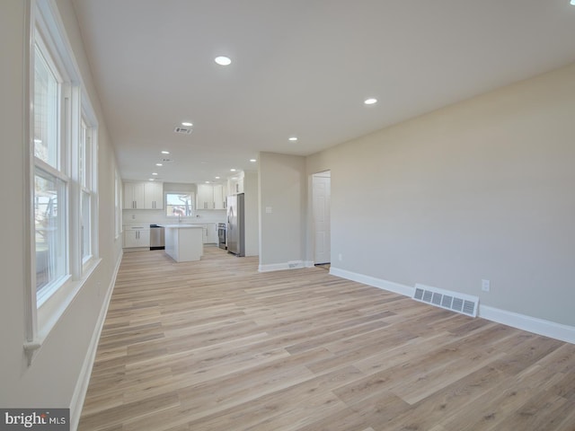 unfurnished living room with light hardwood / wood-style flooring