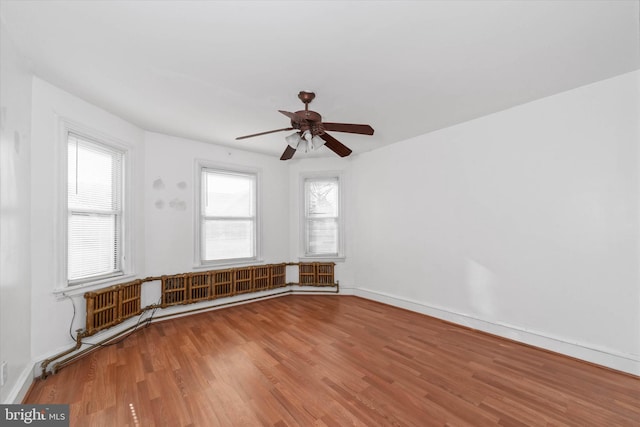 spare room with hardwood / wood-style flooring and ceiling fan