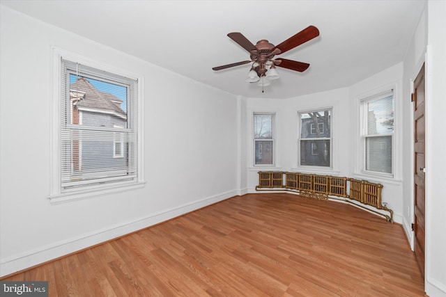 unfurnished room featuring ceiling fan and light wood-type flooring