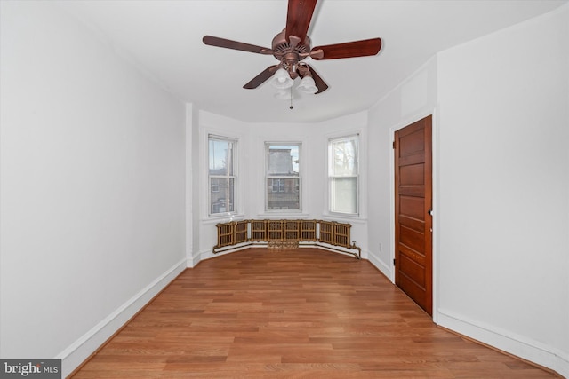 unfurnished room featuring light hardwood / wood-style flooring and ceiling fan