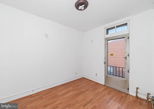 spare room featuring light hardwood / wood-style flooring