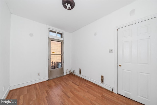 empty room with light hardwood / wood-style flooring