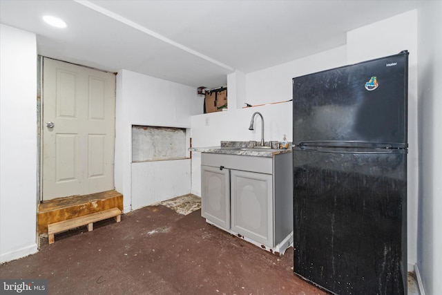 kitchen with black refrigerator and sink