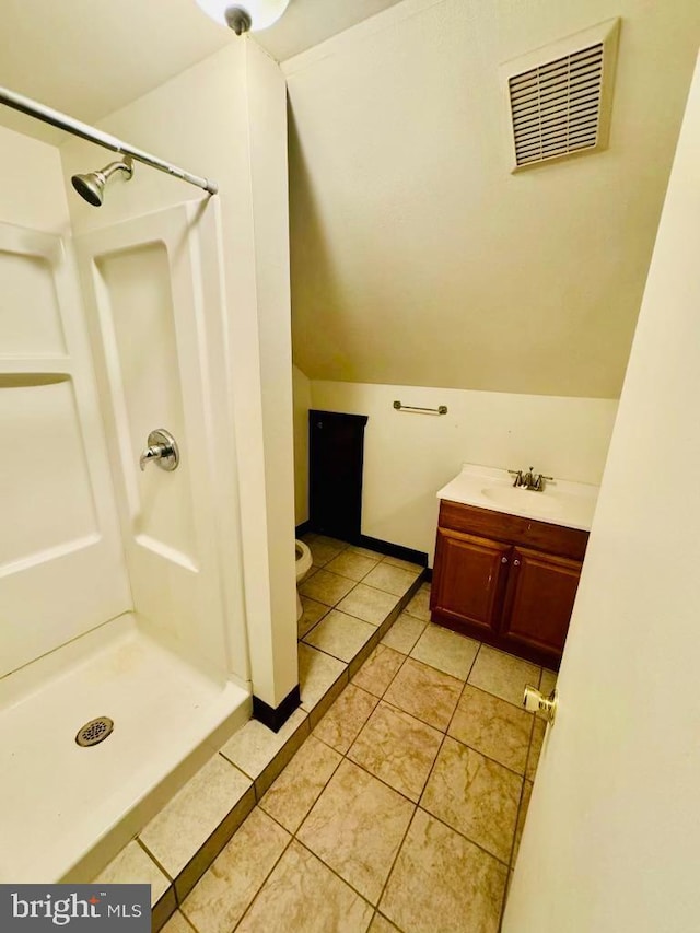 bathroom with vanity, tile patterned floors, and a shower