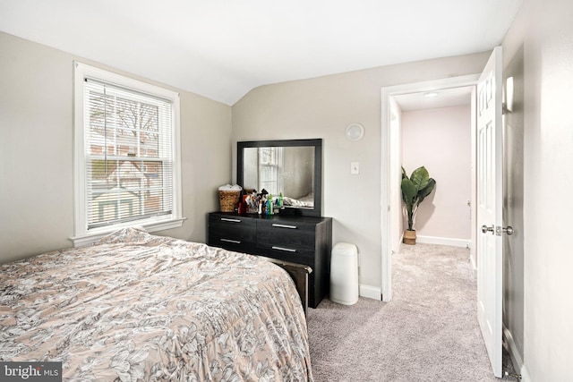 bedroom featuring light carpet and lofted ceiling