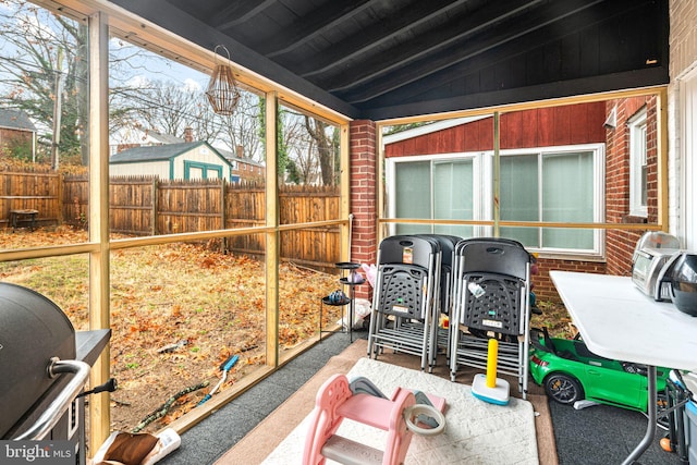 sunroom / solarium with lofted ceiling with beams