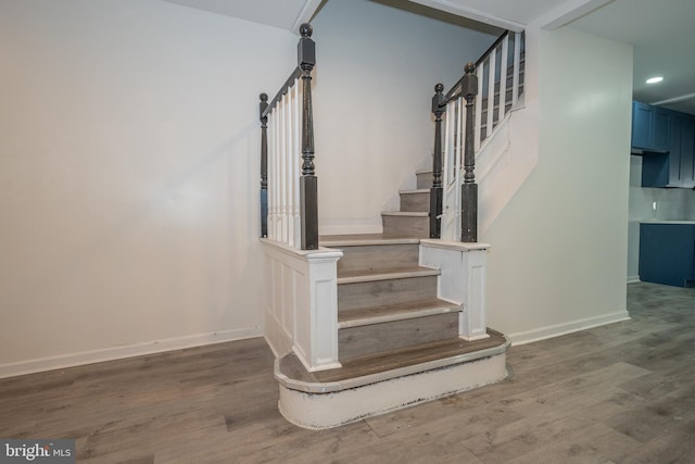 stairs with hardwood / wood-style floors