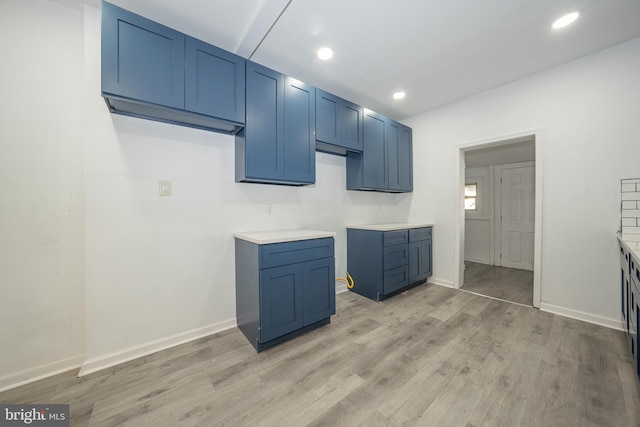 laundry area with light hardwood / wood-style flooring