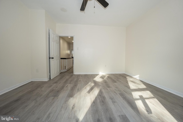 spare room with light hardwood / wood-style floors and ceiling fan