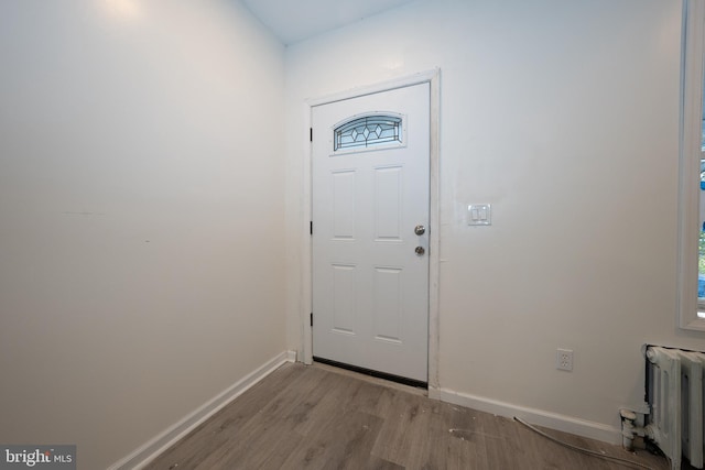 entryway featuring radiator heating unit and light hardwood / wood-style floors