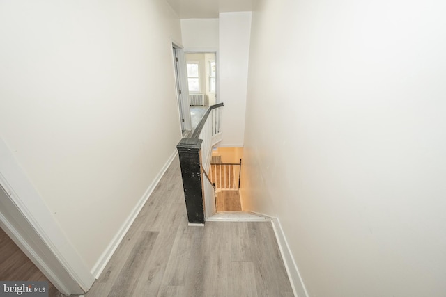 corridor with light hardwood / wood-style floors