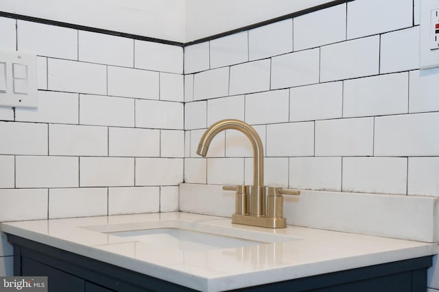 bathroom featuring decorative backsplash and sink