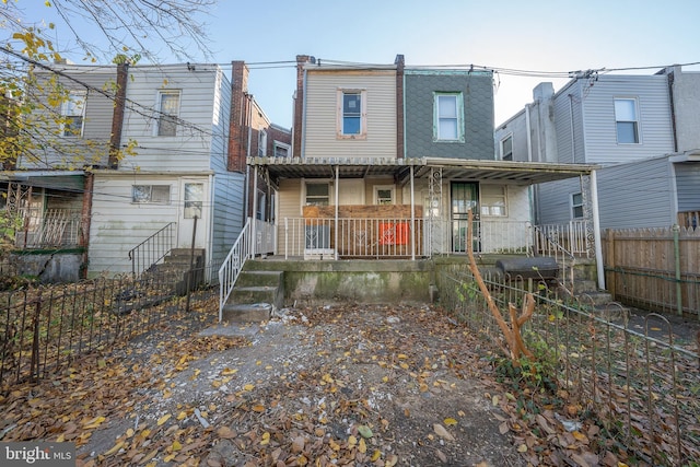 back of property featuring a porch