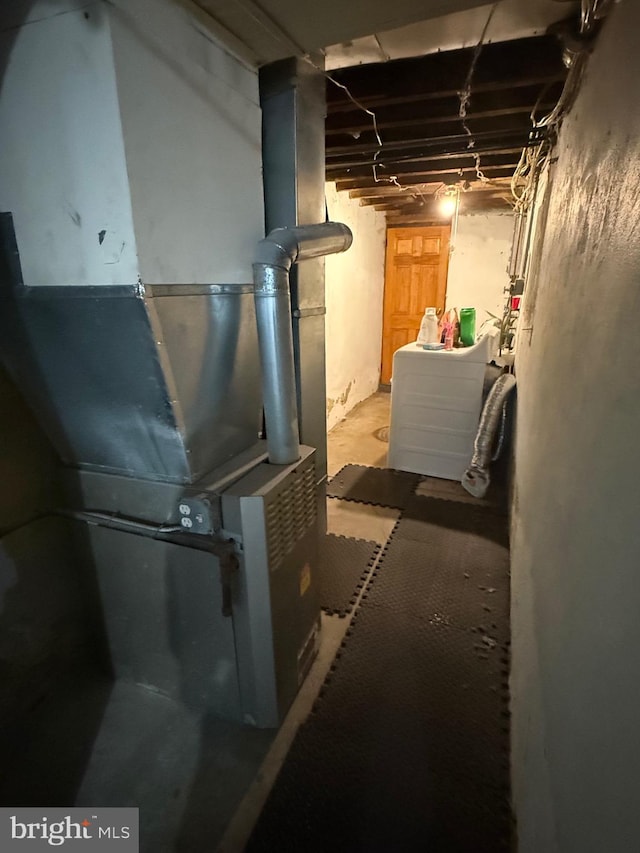 basement featuring washer / clothes dryer and heating unit