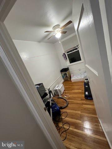 interior space with wood-type flooring and a wall unit AC