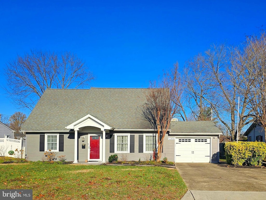 view of front of home with a garage and a front yard