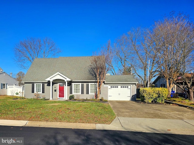 view of front of property with a front yard and a garage