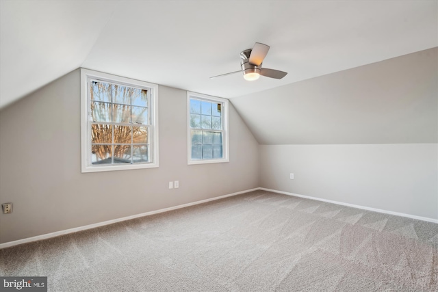 additional living space featuring vaulted ceiling, ceiling fan, and carpet