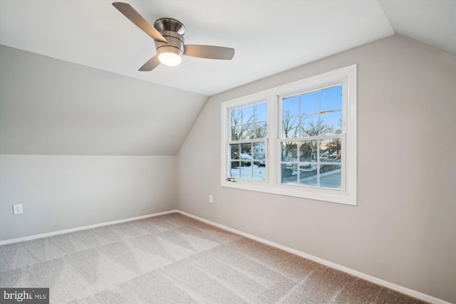 additional living space featuring ceiling fan, light colored carpet, and vaulted ceiling