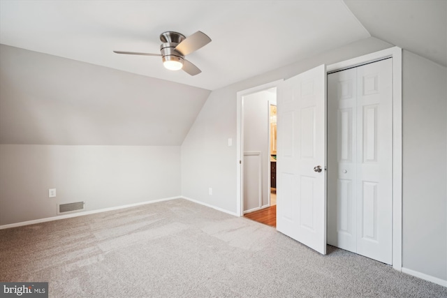 bonus room with ceiling fan, lofted ceiling, and light carpet