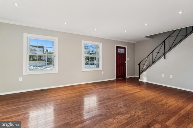 entryway featuring dark wood-type flooring and crown molding