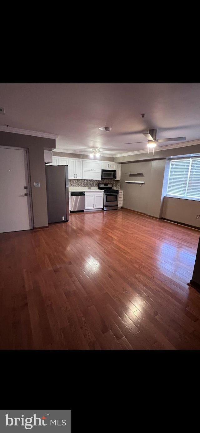 unfurnished living room with dark hardwood / wood-style flooring and sink