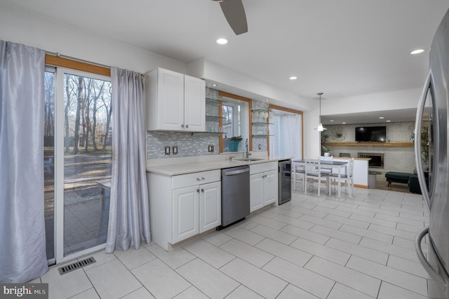 kitchen featuring appliances with stainless steel finishes, backsplash, beverage cooler, pendant lighting, and white cabinetry